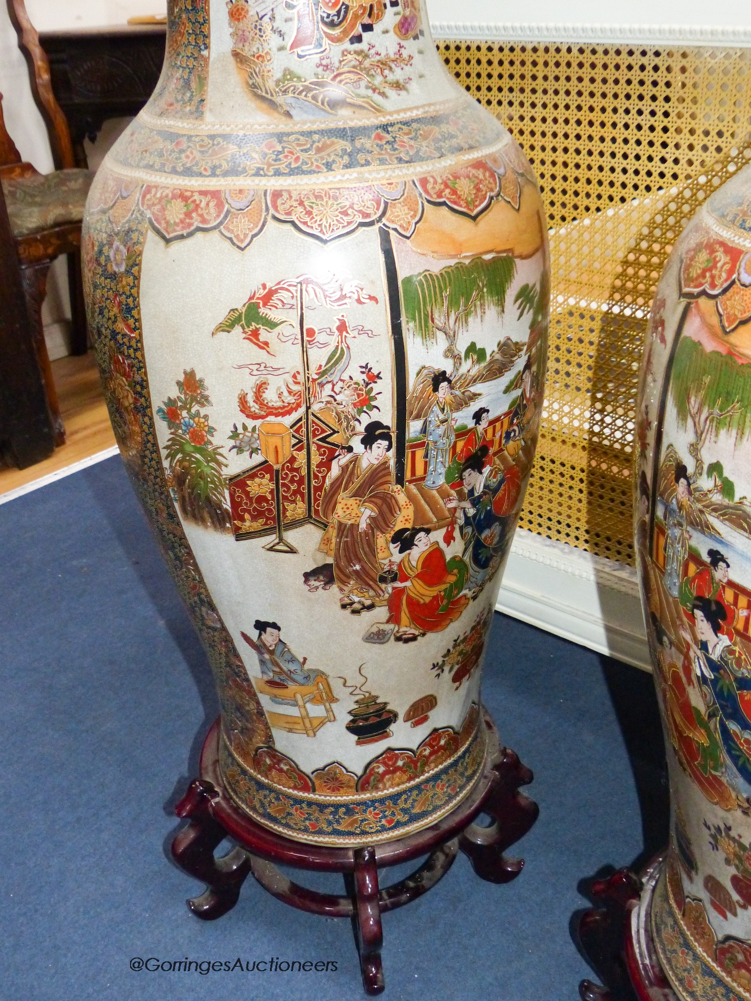 A pair of large Japanese vases, on hardwood stands